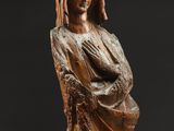 a wooden statue of a woman with a veil on her head