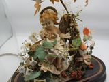 une figurine représentant un ange tenant un panier rempli de fleurs