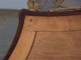a wooden bed with a mirror on top of it