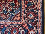 an oriental rug on the floor with a cat sleeping on top of it
