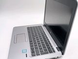 a silver laptop with a blue sticker on it