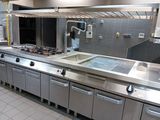 a large kitchen with stainless steel appliances in it