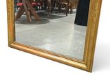 a large mirror that is sitting on the floor