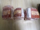 three bags of meat sitting on top of a table next to each other