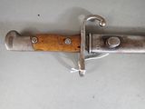 a close up of a knife with a wooden handle