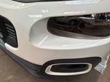 a close up of a white car in a showroom