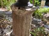 a statue of a man sitting on top of a stone pedestal