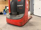 a red fork lift truck parked in a garage