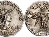 a silver coin with an image of a woman and a man on it