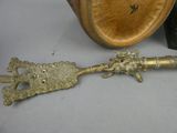 a metal spoon with a handle that has a lion head on it