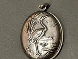 a silver locke with a picture of a bird on it