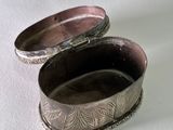 a silver box that is sitting on a white surface