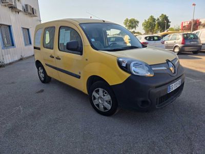 the small yellow van is parked in the parking lot