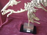 a statue of a bird with wings on a stand