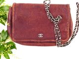 a brown purse with a chain hanging from it ' s side