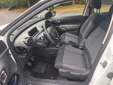 the interior of a car with the door open showing the driver ' s seat
