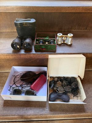 two boxes of coins and a pair of binoculars on the stairs