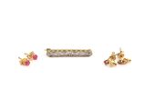three pairs of earrings and a ring on a white surface