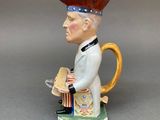 a figurine of a man with a hat on his head