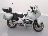 a blue motorcycle that is parked in a white room