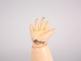 wooden hand with a hole in the middle of it on top of a table