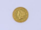 a close up of a gold coin on a white surface