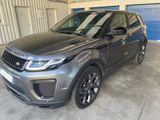 a grey land rover parked in a garage