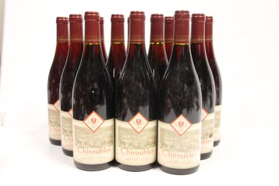 six bottles of wine are lined up in a row on a white surface