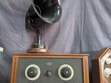 two old fashioned radio ' s on a table with a red cloth