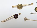 a lot of pins and brooches on a white surface