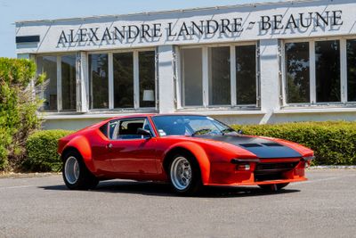 an image of a red sports car parked in front of a building