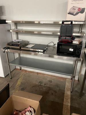 a kitchen with a stove, microwave, and other appliances in it