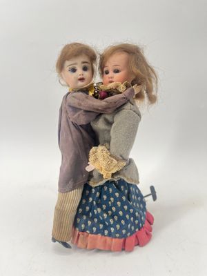 two dolls that are standing next to each other
