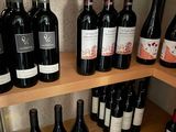 many bottles of wine on the shelves in the kitchen