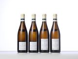 three bottles of wine are lined up on a table