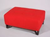a red ottoman with black legs on a white background