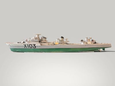 a model of a boat on a gray surface