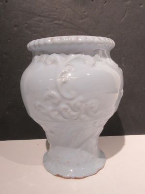 a white vase that is sitting on a table