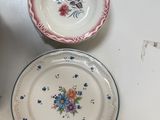 two plates and a bowl sitting on a table