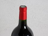 a bottle of wine sitting on a wooden table
