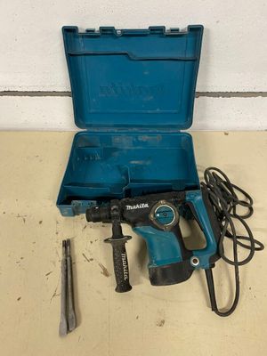 a blue tool box with a hammer, drill and other tools