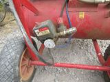 a red gas tank with a hose attached to it