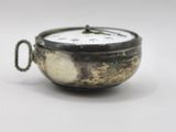 a small silver clock sitting on top of a white table