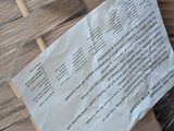 a piece of paper sitting on top of a wicker basket
