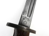 a close up of a knife on a white surface
