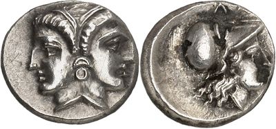 a silver coin with a woman and a man on it