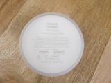 a white plate with a label on it on a wooden table