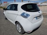 a small white car parked on the side of the road