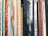 many books that are on a shelf in the room