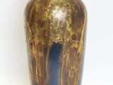 a vase that is sitting on a white surface
